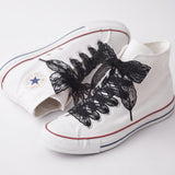Lacets en dentelle noirs longs sur Converse montantes blanches